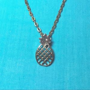 gold pineapple charm on a golden chain